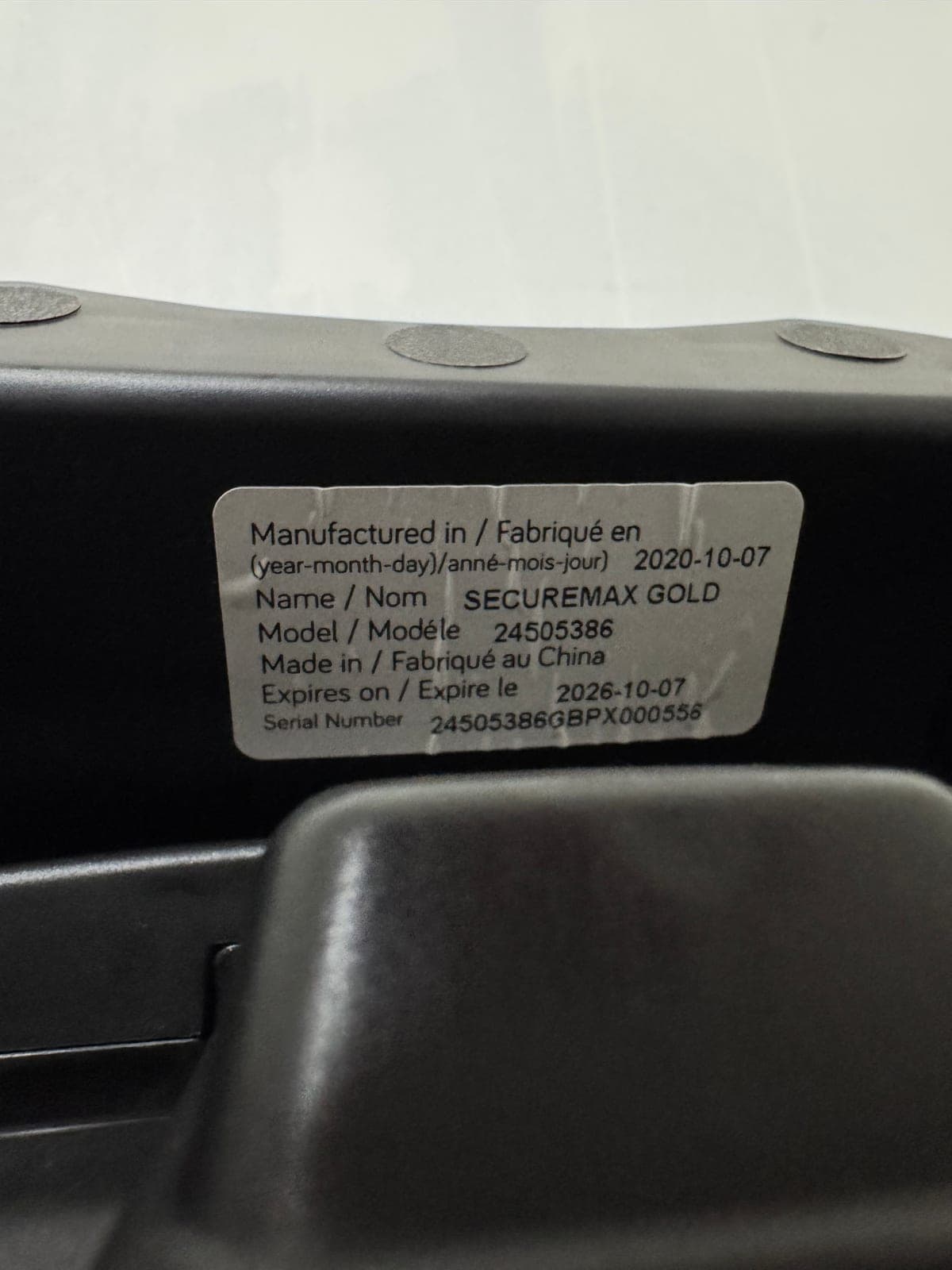 Sticker on the plastic shell of a car seat showing its expires on date