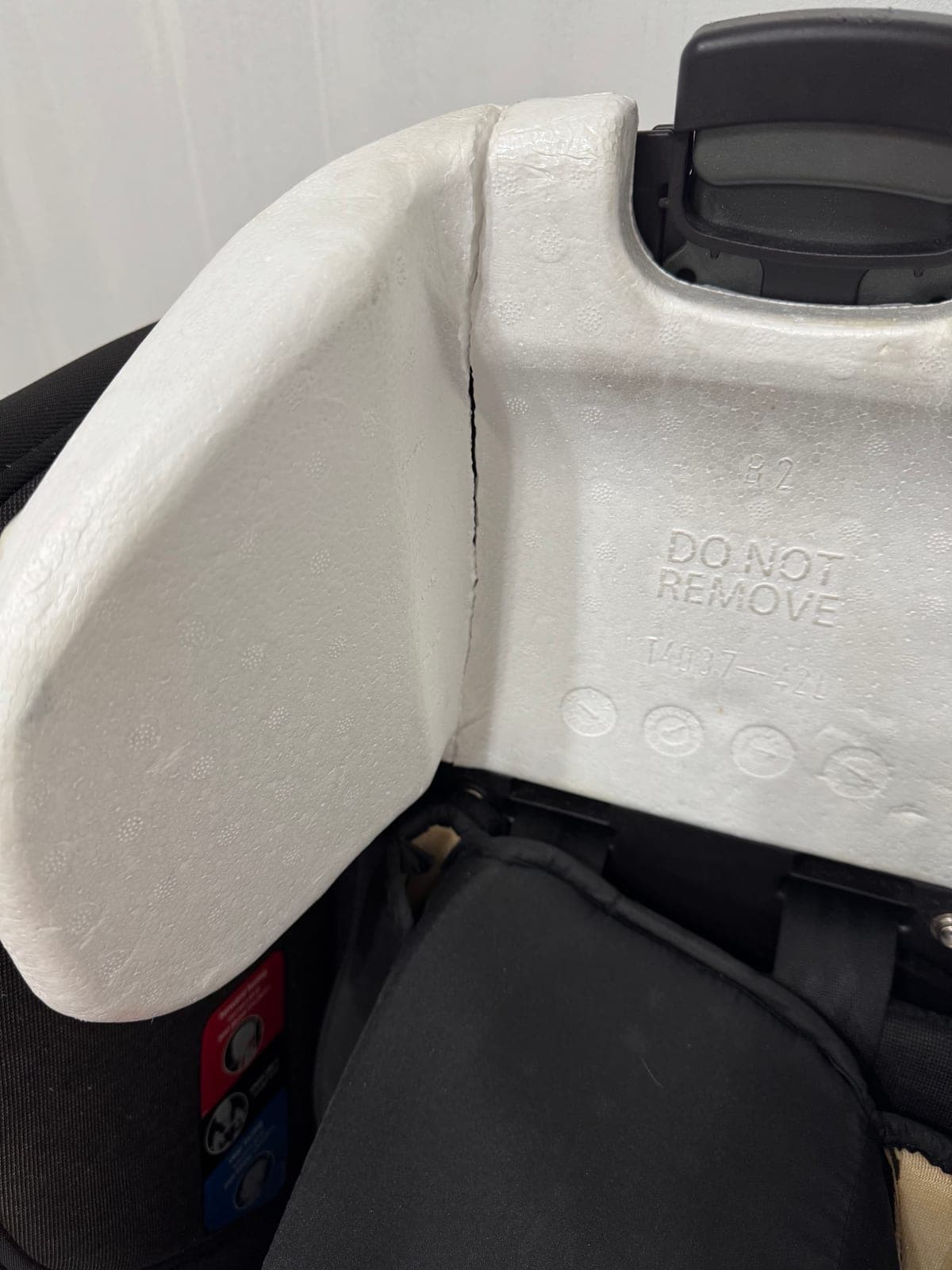 Car seat headrest foam with a crack running through one side wing