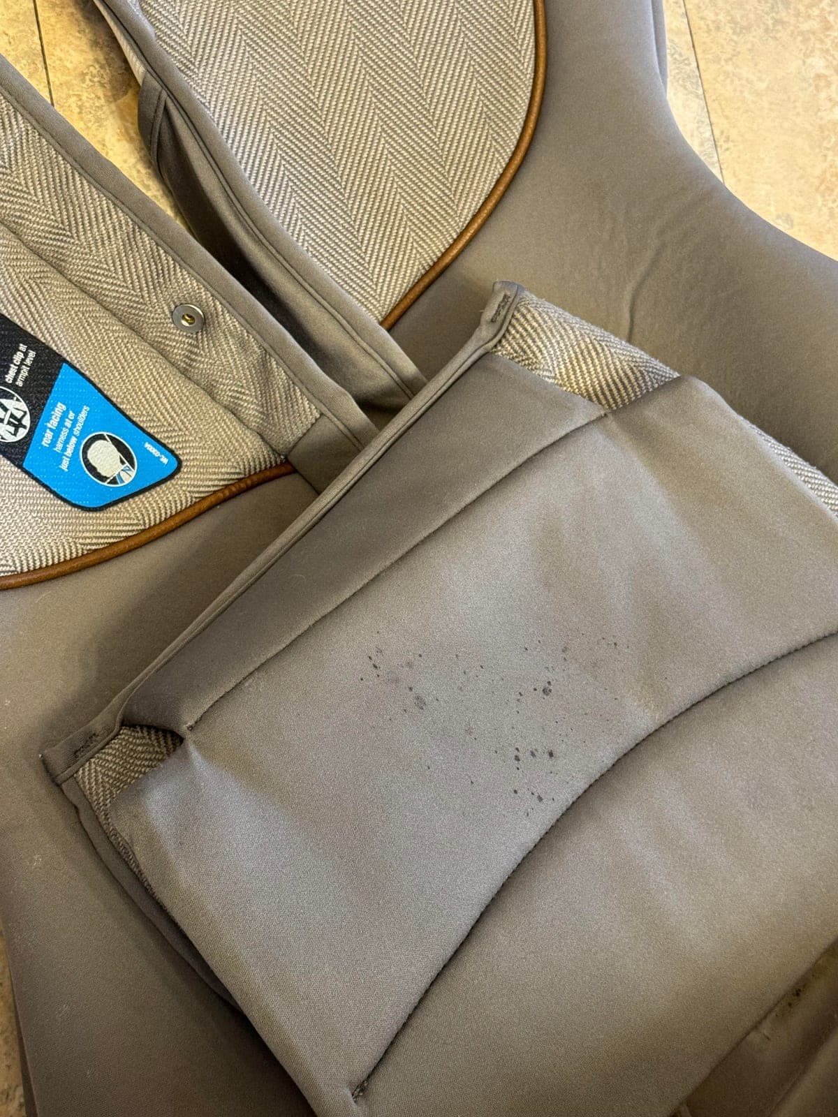 Dark speckled mold spots on a car seat fabric cover